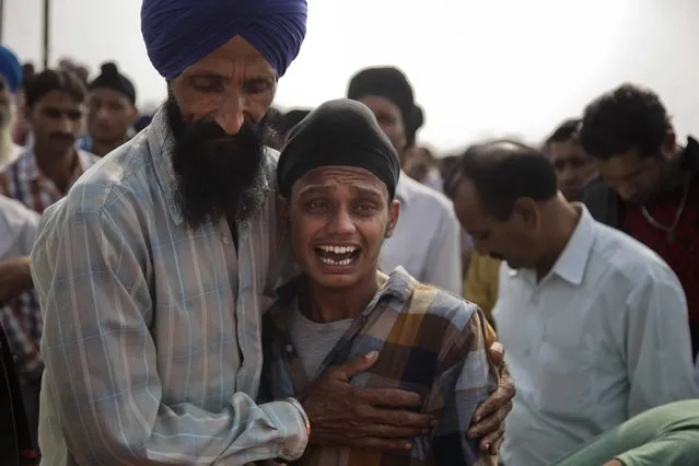 Brother of Indian woman Rajinder Kaur, who was killed in Pakistani shelling wails during her funeral at Khour village in Ramgarh sector, Samba district of Jammu and Kashmir, India, Tuesday, November 1, 2016. Six civilians were killed and nine others wounded by Pakistani shelling in Kashmir on Tuesday, Indian officials said, as cross-border firing by the two countries' troops escalated in the disputed region. (Photo by Channi Anand/AP Photo)