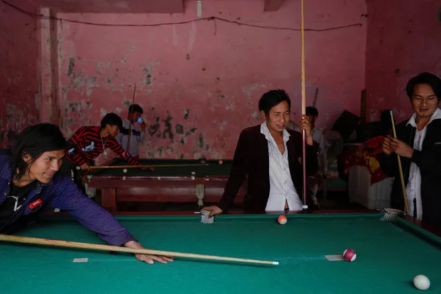 Ethnic Lisu men play a game of billiards in Daxindi township of Nujiang Lisu Autonomous Prefecture in Yunnan province, China, March 24, 2018. (Photo by Aly Song/Reuters)