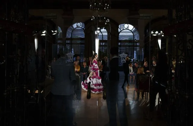 A model wearing a flamenco dress walks along the catwalk during the “We Love Flamenco” fashion show in the Andalusian capital of Seville January 14, 2015. (Photo by Marcelo del Pozo/Reuters)