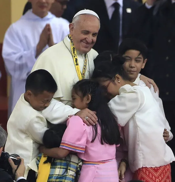 Pope Francis hugs children during a meeting with the youth at the University of Santo Tomas in Manila January 18, 2015. (Photo by Romeo Ranoco/Reuters)