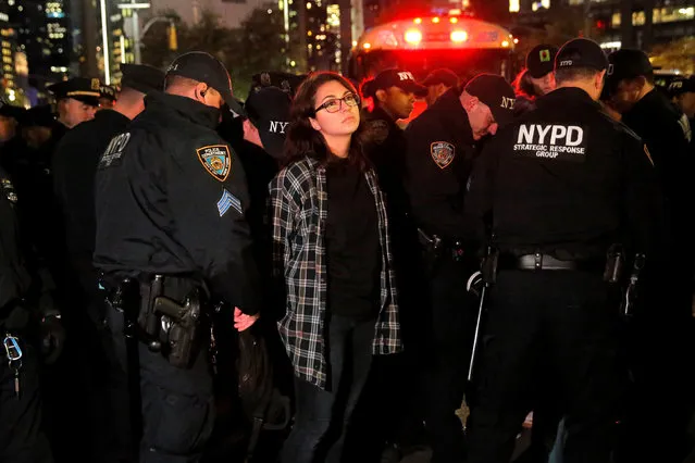 A woman is detained during a protest outside the Trump International Hotel and Tower following President-elect Donald Trump's election victory in Manhattan, New York, U.S., November 9, 2016. (Photo by Andrew Kelly/Reuters)