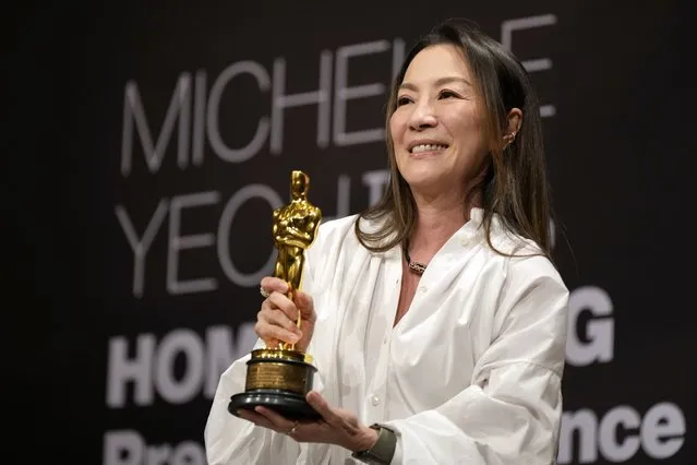 Malaysian actress Michelle Yeoh holds up the Oscar statuette during a press conference in Kuala Lumpur, Malaysia, Tuesday, April 18, 2023. Yeoh won the award for best performance by an actress in a leading role for “Everything Everywhere All at Once” at the Oscars on March 12. (Photo by Vincent Thian/AP Photo)