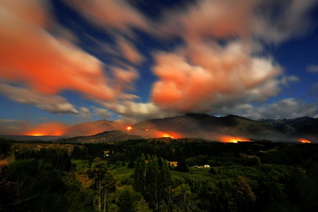 Flames and smoke rise from a wildfire in Epuyen, in the Patagonian region of Chubut, Argentina on January 16, 2025. (Photo by Matias Garay/Reuters)