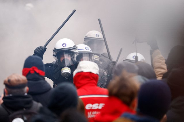 Riot police wield their batons as they confront demonstrators, at a national strike by workers and trade union members, who are demanding stronger public services in Brussels, Belgium on February 13, 2025. (Photo by Stephanie Lecocq/Reuters)