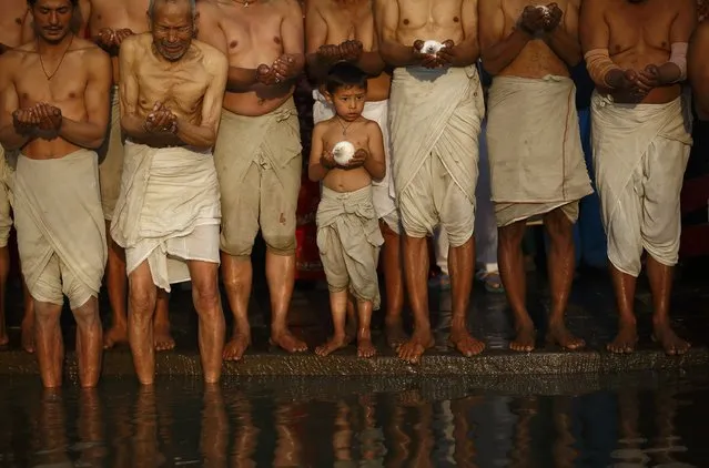 Devotees offer prayer as they stand on the bank of the Hanumante River during the final day of the month-long Swasthani festival at Bhaktapur, near Kathmandu, February 3, 2015. (Photo by Navesh Chitrakar/Reuters)