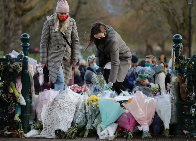 People leave floral tributes, at the band stand in Clapham Common, after a vigil for Sarah Everard was officially cancelled, in London, Saturday, March 13, 2021. A serving British police officer accused of the kidnap and murder of a woman in London has appeared in court for the first time. Wayne Couzens, 48, is charged with kidnapping and killing 33-year-old Sarah Everard, who went missing while walking home from a friend’s apartment in south London on March 3. (Photo by Frank Augstein/AP Photo)