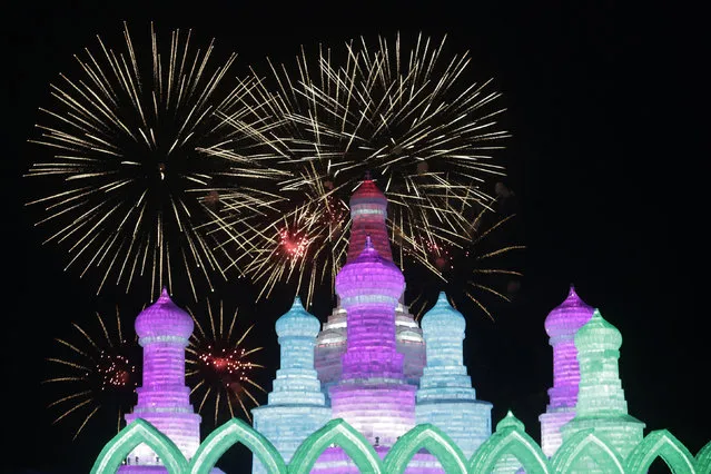Fireworks light up the sky behind ice and snow sculptures during the Harbin International Ice and Snow Festival in the northern city of Harbin, Heilongjiang province, China, January 5, 2016. (Photo by Aly Song/Reuters)
