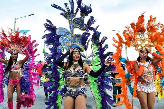 Honduran dancers perform in the streets, during the anticipated celebration of the 440th Anniversary of Tegucigalpa, in Honduras, on September 22, 2018. Tegucigalpa was founded on September 29, 1579, by the Spaniards as a mining town due to its silver deposits. (Photo by Orlando Sierra/AFP Photo)
