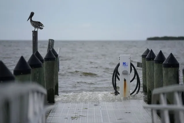 Waves wash over a dock in Cedar Key, Fla., ahead of the expected arrival of Hurricane Idalia, Tuesday, August 29, 2023. (Photo by Rebecca Blackwell/AP Photo)